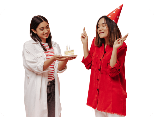 Two friends celebrating with a birthday cake