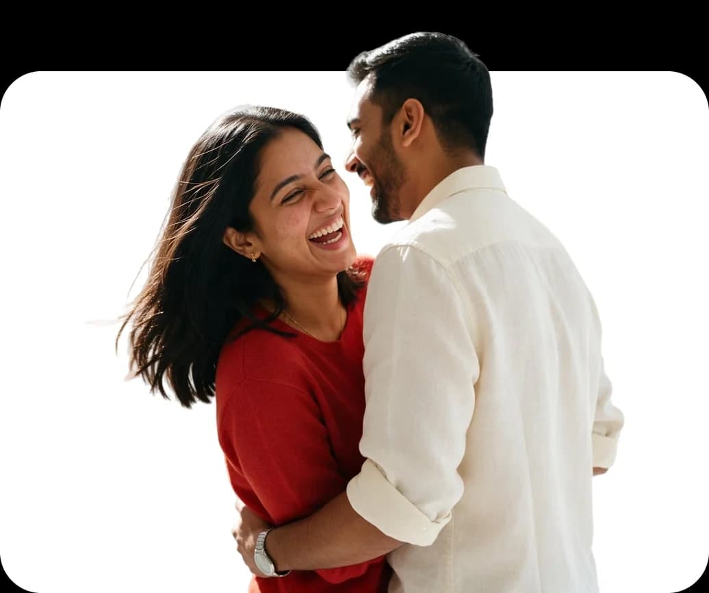 A young couple holding each other and laughing together