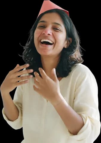 A young woman in a paper party hat laughing